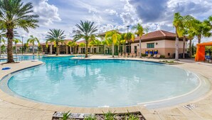 A large outdoor swimming pool surrounded by palm trees and a building with a tiled roof. - Solterra Escape | Private Pool | Café, Tennis & Water Park with Lazy River (Davenport)