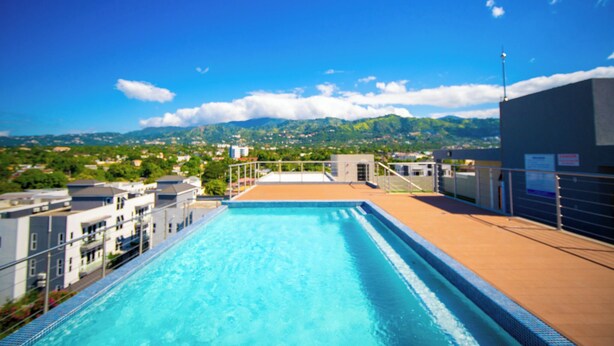 A rooftop swimming pool with a view of a mountainous landscape. -  1 bdrm  apartment  roof top pool, gym, mountain views, 24 hr security  Barbican (Kingston)