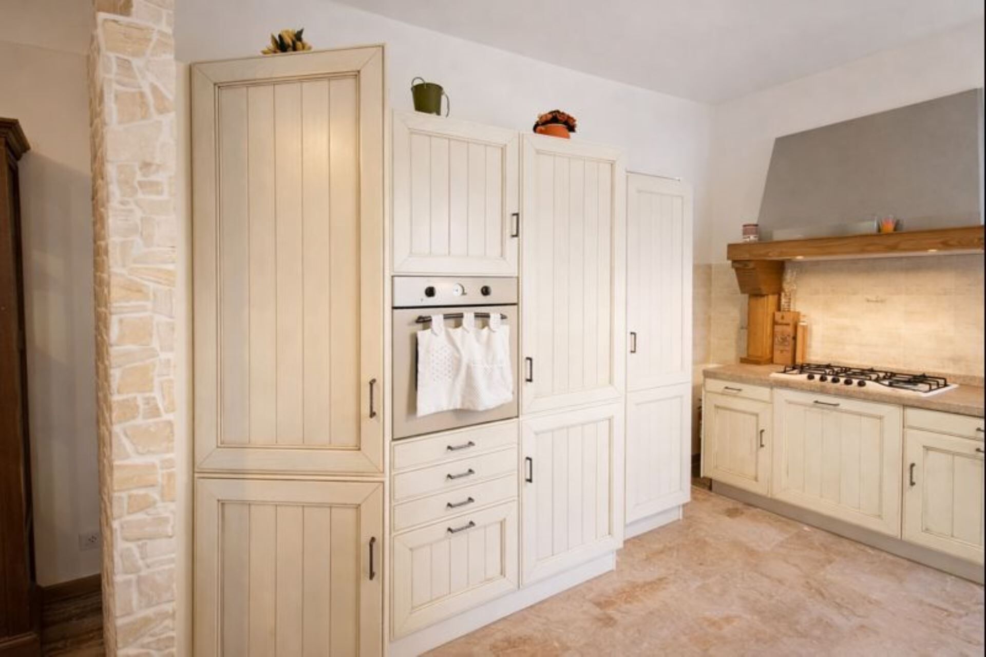 A kitchen with white cabinetry, a built-in oven, and a gas stove.
