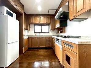 Apartment | Private kitchen | Full-size fridge, microwave, stovetop, cookware/dishes/utensils - Yokohama Mega Stay (Yokohama)