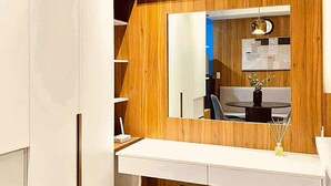 A modern bathroom with a vanity, mirror, and wooden paneling.