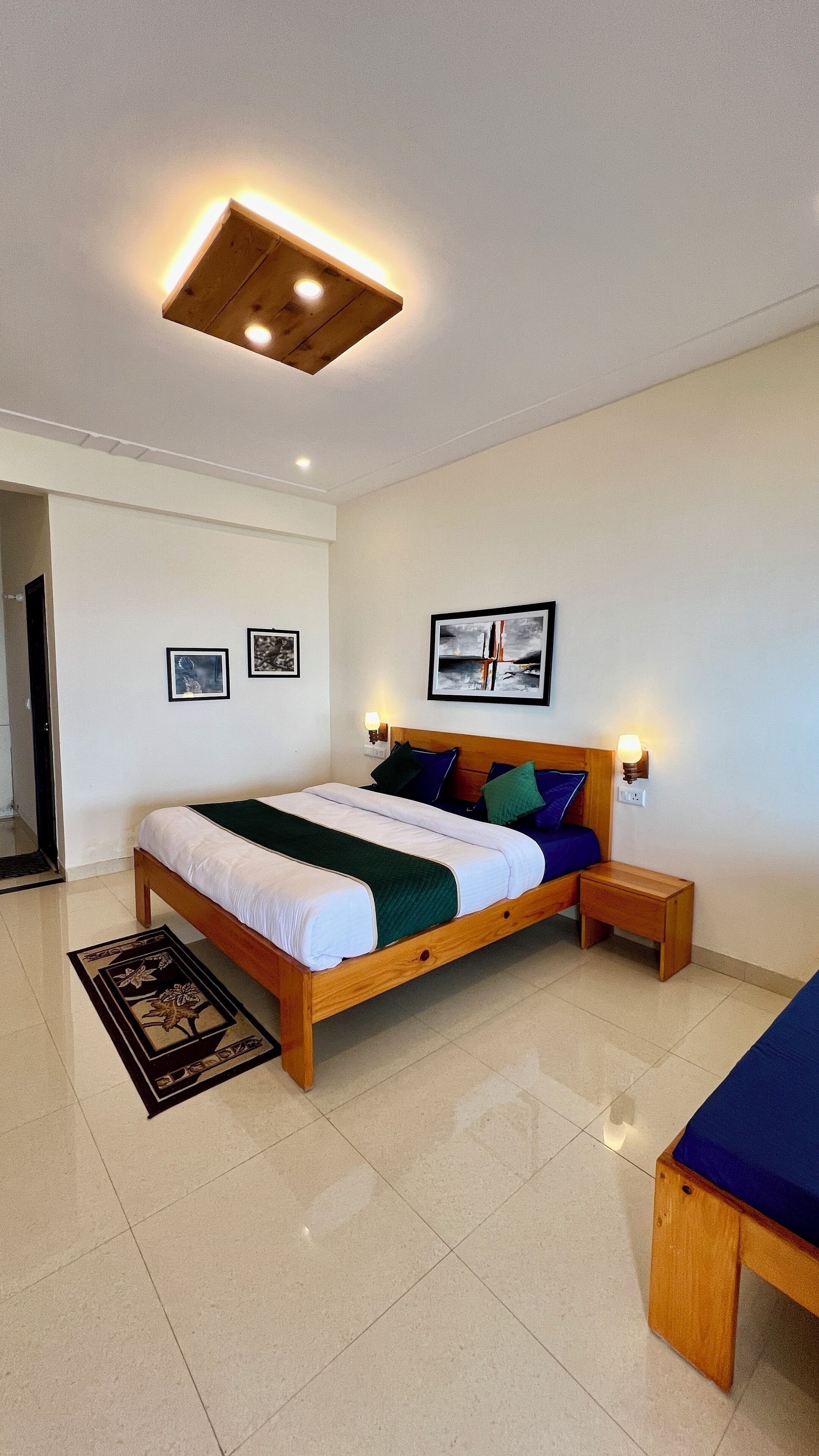 A modern bedroom with a wooden bed, a nightstand, a bedside table, and a floor lamp.