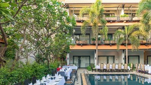 A hotel with a pool, outdoor dining area, and lush greenery. - The Sears Residence (Siem Reap)