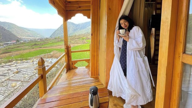 A wooden balcony with a view of a valley and mountains. - Sonam Zhidhey Resort  (Ha)