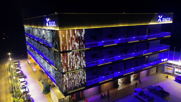 A multi-story building with a prominent sign for 'XIAO'S' on the top.