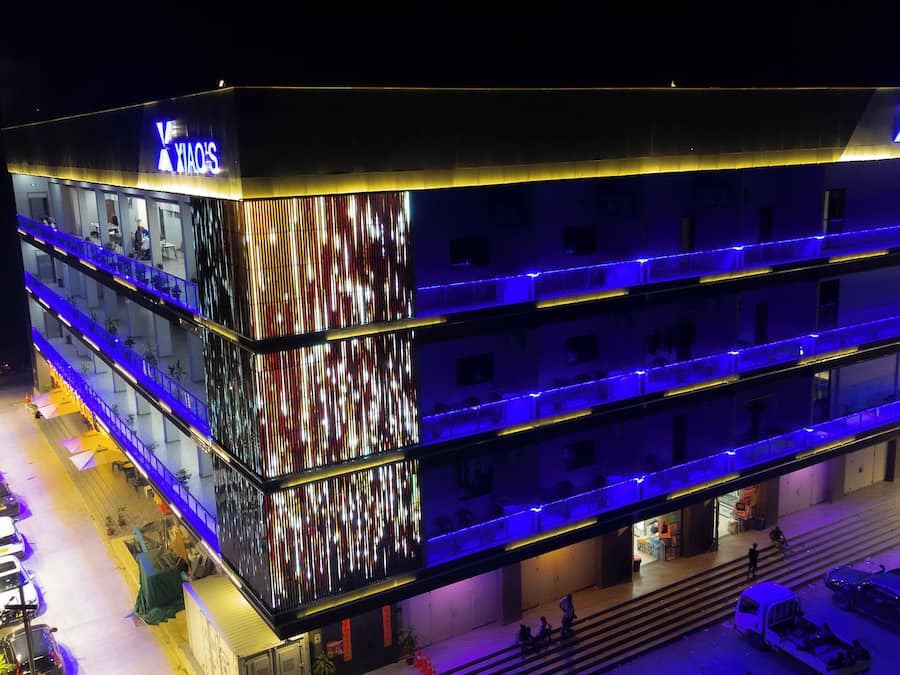 A multi-story building with a prominent sign for 'XIAO'S' on the top.