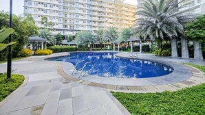 A swimming pool surrounded by greenery, with a gazebo and a lamp post. - Maree- Verdon Parc, Davao City (Davao City)