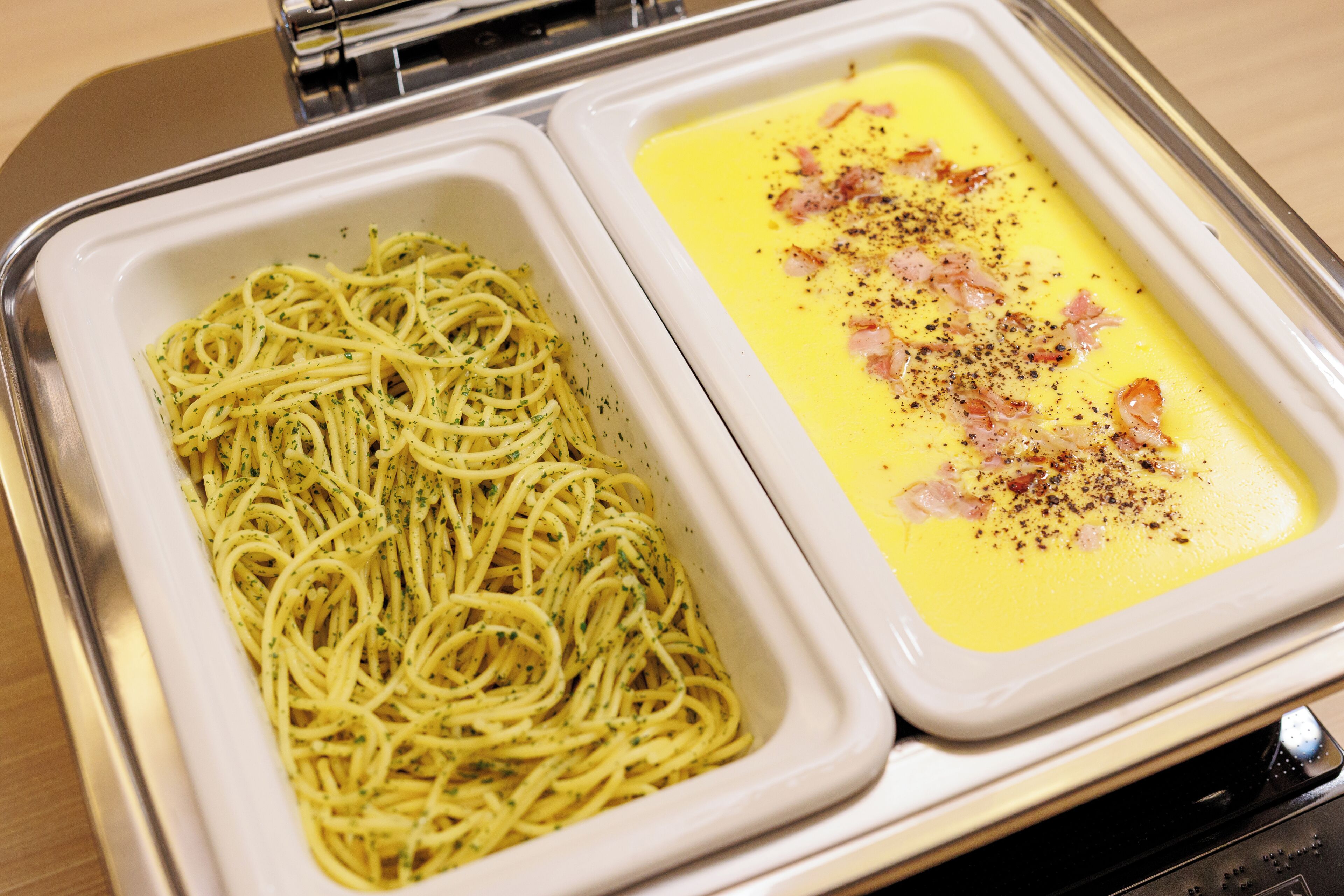 A tray with spaghetti and a creamy soup.