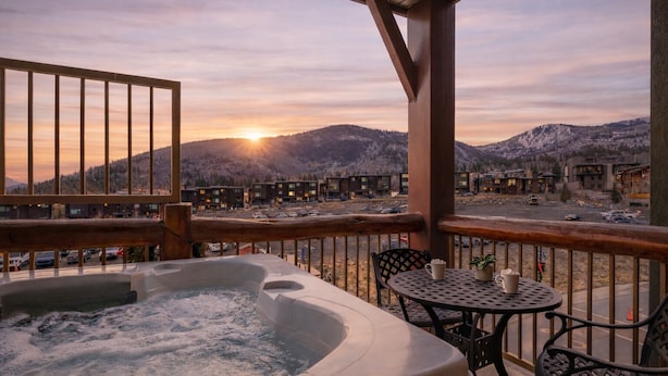 A hot tub on a balcony with a view of a mountain and buildings in the background. - Ski-In Ski-Out Home + Hot Tub + Resort Amenities + Alpine Views | Highline Lodge (Park City)