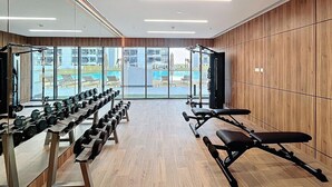 A gym with weight benches, dumbbells, and exercise equipment. - Modern Studio l Community Views l Free Gym, Pool (Studio City)