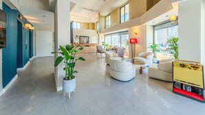 A spacious lobby with a high ceiling, modern seating, and large windows. - Nenesa Hotel İstanbul Airport  (Arnavutkoy)