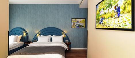 A bedroom with two beds, a large painting on the wall, and a wooden floor.