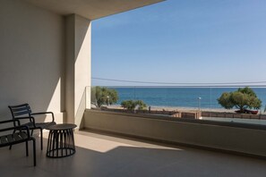 A balcony with a view of the sea, a chair, a small table, and a potted plant. - Gemini Villas Chania | Complex of 2 villas (Maleme)