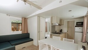 A compact living space with a kitchenette, a dining area, and a seating area.