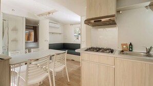 A modern kitchen with a gas stove, wooden cabinets, and a built-in oven.