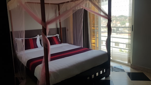 Un lit à baldaquin, un balcon avec vue et un design moderne pour la chambre.