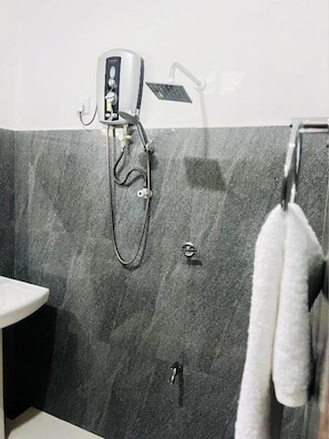 A bathroom with a shower, a sink, and a towel rack. - Wild Blossom Sigiriya (Sigiriya)