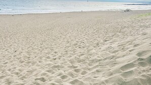 A sandy beach with footprints and a pair of flip-flops. - Stopover Between Tokyo&Osaka/ Traditional House/ Live Like a Local/ King Bed (Fudabacho, Hiratsukashi)