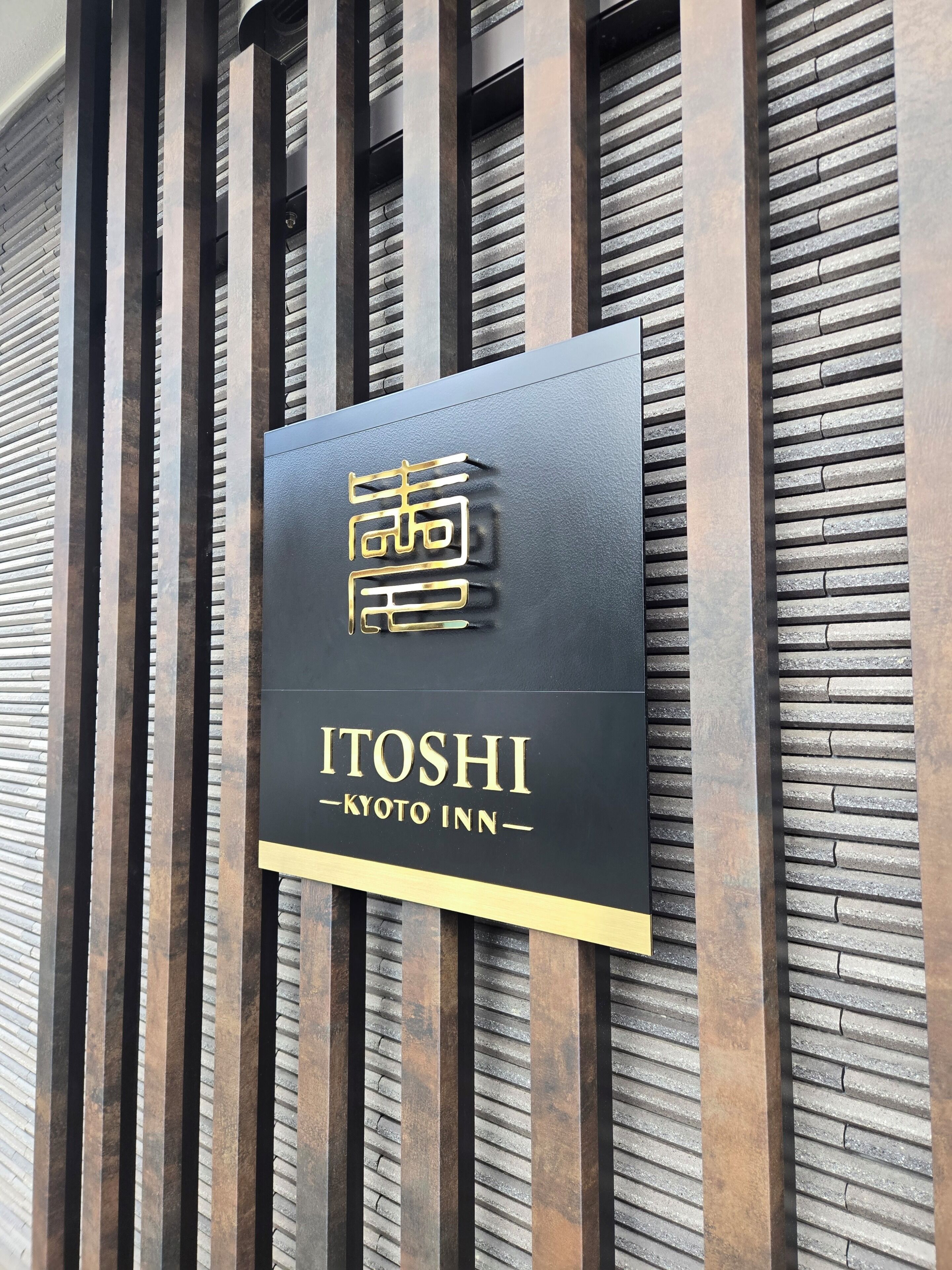 A sign for the Kyoto Inn with a modern design.