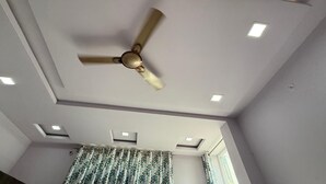 A room with a ceiling fan, recessed lighting, and an air conditioning unit. - Hotel The Gold by Yatrik Hotels (Jaipur)