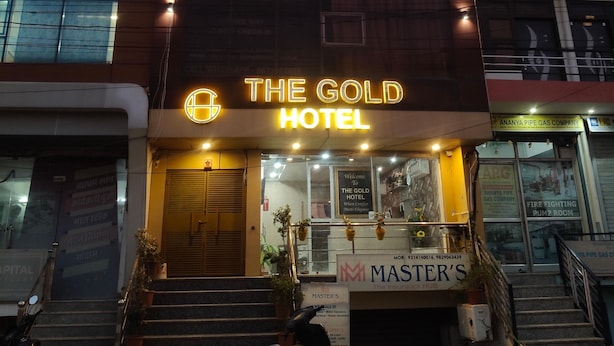 A hotel named "The Gold Hotel" with a modern facade, a visible entrance, and a sign for "Master's The Insurance Hub" below. - Hotel The Gold by Yatrik Hotels (Jaipur)