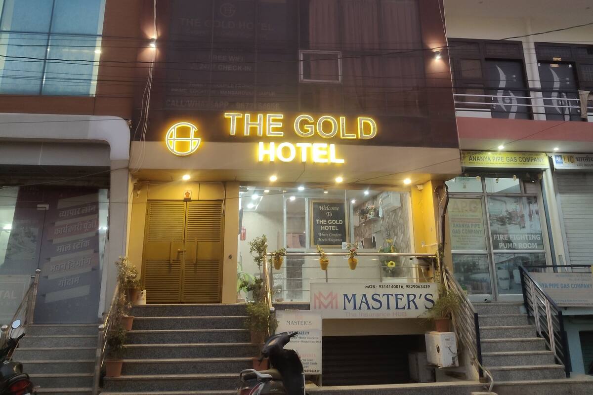 A hotel with a prominent sign reading "The Gold Hotel."