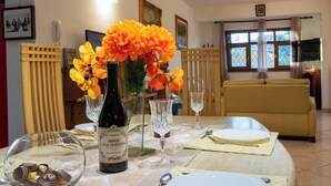 A dining table set with a bottle of Amarone wine, glasses, and a plate of food. - tre fontane by Interhome (Monsummano Terme)