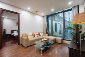 Deluxe Studio, 2 Queen Beds, Bathtub, City View | Living area - Sakamoto 1 Apartments by XÔI Residences (Giang Vo)