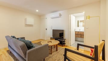 Apartment, 1 Bedroom | Living area | 32-inch flat-screen TV with cable channels