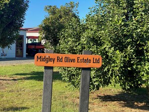 A sign for Midgley Rd Olive Estate Ltd.
