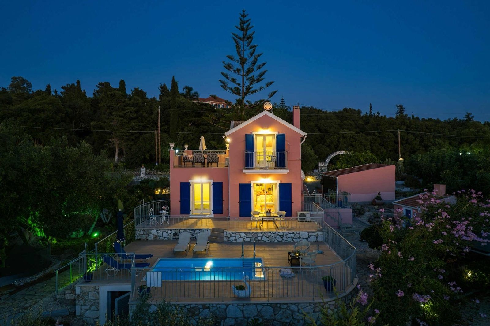 A two-story house with a balcony and a swimming pool.