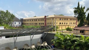 A rooftop pool with a hot tub, surrounded by lounge chairs and a covered seating area. - GREYFIELD APARTMENT 2 (Benin City)