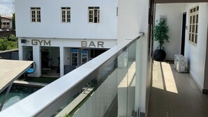 A modern building with a sign for 'GREEYFIELD APARTMENT' and a 'GYM BAR' below. - GREYFIELD APARTMENT 2 (Benin City)