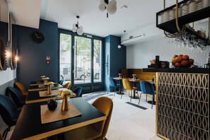 A modern restaurant interior with a bar area, dining tables, and chairs. - Hotel M4 Boutique (Kraków)