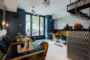 Un interno di ristorante moderno con zona bar, tavoli e sedie.