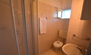 A small bathroom with a shower, toilet, and sink. - Residence With Pool in Lignano Riviera (Lignano Sabbiadoro)