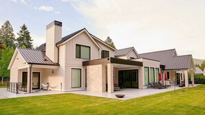 A modern two-story house with a covered patio, large windows, and a well-maintained lawn. - FIFA World Cup. Brand new 6 BD, 8 BA, Whiskey Room, Games room+ more (West Vancouver)