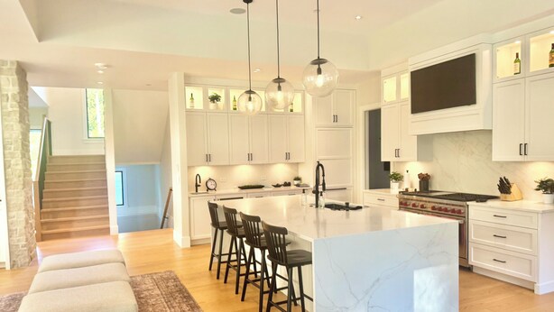A modern kitchen with white cabinets, a marble island, pendant lights, and a built-in oven. - FIFA World Cup. Brand new 6 BD, 8 BA, Whiskey Room, Games room+ more (West Vancouver)