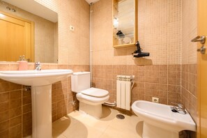 A bathroom with a sink, toilet, and bidet. - 2-Bedroom Apartment Steps Away from Gran Vía: Live in the Heart of Madrid (Madrid)
