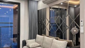 Deluxe Apartment, 2 Bedrooms, Balcony, City View | Living area | 30-inch LCD TV with digital channels