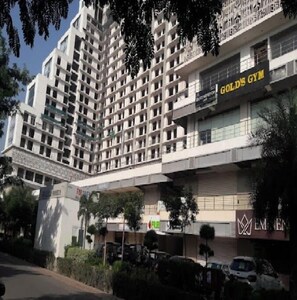A multi-story hotel with a modern design, featuring a prominent gym on the ground floor.