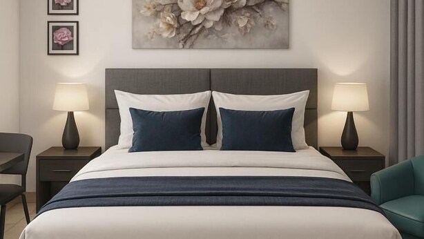 A modern hotel bedroom with a large bed, two bedside tables, a ceiling fan, and a floral artwork on the wall. - Deutsch Inn Luxury Apt (Weija)