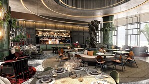A modern interior with a bar area, seating arrangements, and a staircase. - ART Riverfront Hotel Tbilisi (Tbilisi)
