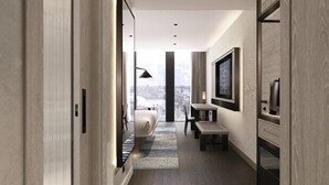A modern hotel hallway with a view to the city, a bed, a TV, and a desk. - ART Riverfront Hotel Tbilisi (Tbilisi)