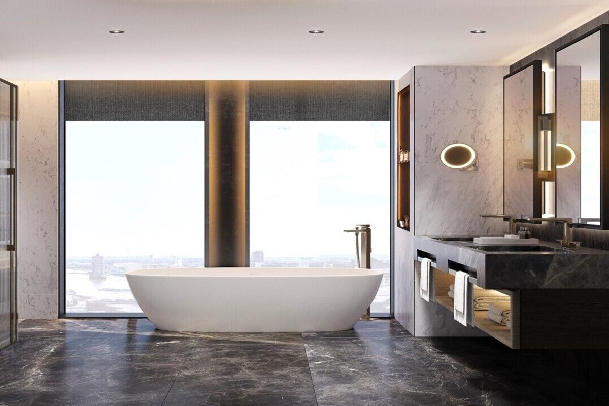 A modern bathroom with a freestanding bathtub, a large mirror, and a view of a cityscape.