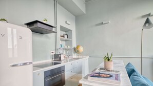 A modern kitchen with a built-in oven, a sink, and a globe on the countertop. - w Bright 2BR Near Arco Della Pace (Milan)