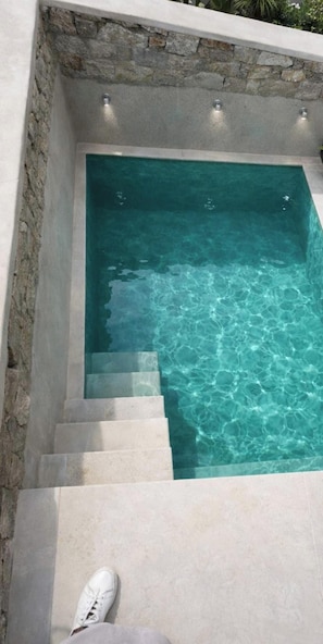 A small, clear pool with steps leading into it, surrounded by stone walls and a tiled floor. - Eidolion Essence - Mykonos Villa With Private Pool (Mykonos)