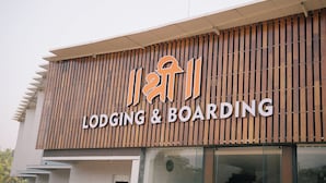 A building with a sign that reads 'LODGING & BOARDING' and features a modern design with vertical wooden slats. - SHREE LODGING & BOARDING (Vasai)