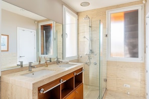 A modern bathroom with a dual sink vanity, a glass shower enclosure, and a large mirror. - Penthouse with stunning TERRACE / Arco de Triunfo (08009 Barcelona)