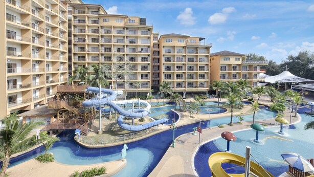 A hotel with multiple balconies, a water park with slides, and a pool area. -  Palette - Gold Coast Morib Resort (Banting)